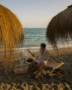 A man sitting in a chair on the beach